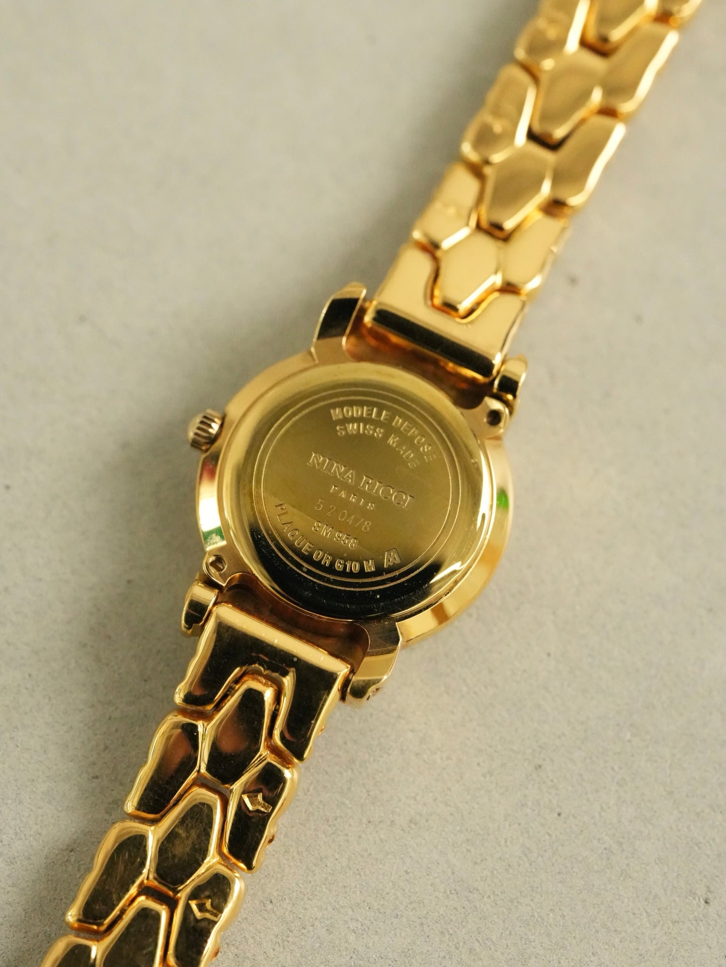 Nina Ricci Mother of Pearl Dial Two-Tone Bracelet Watch – Gold & Silver Belt Design