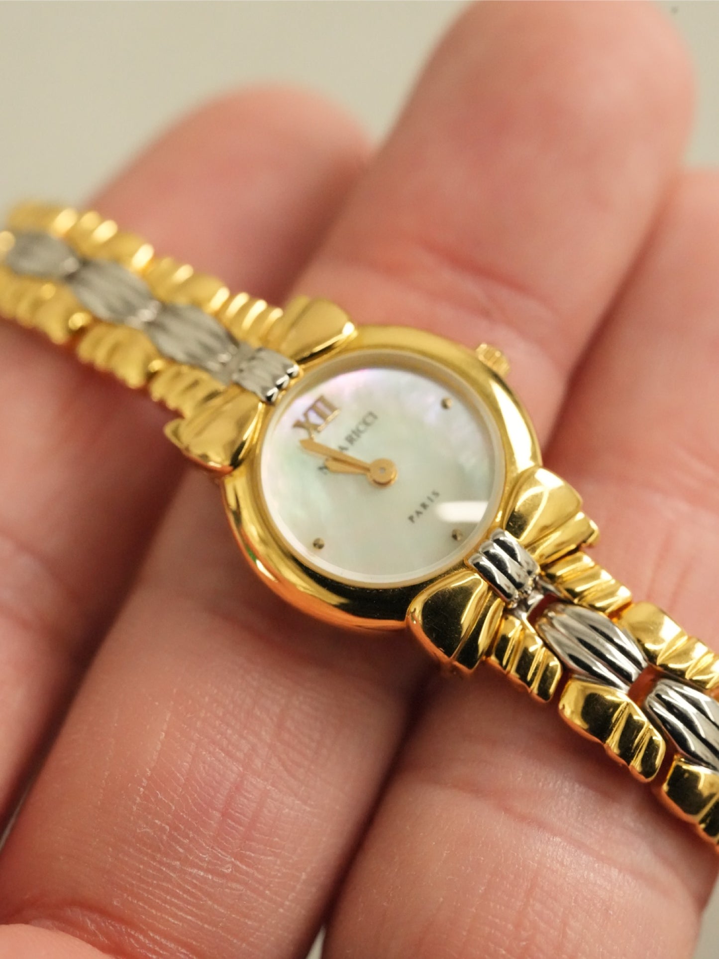 Nina Ricci Mother of Pearl Dial Two-Tone Bracelet Watch – Gold & Silver Belt Design