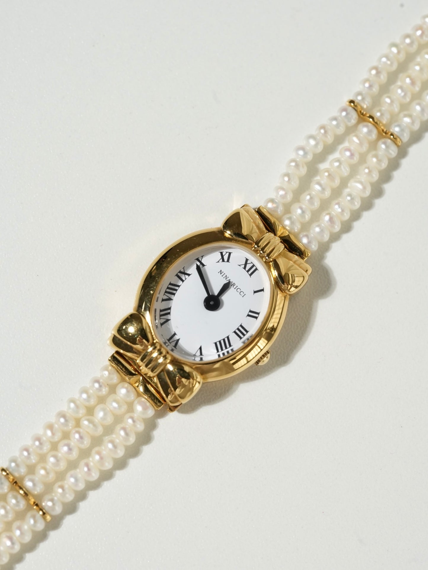 Nina Ricci Pearl Bracelet Watch Set – Gold Case, White Dial with Extra Leather Straps