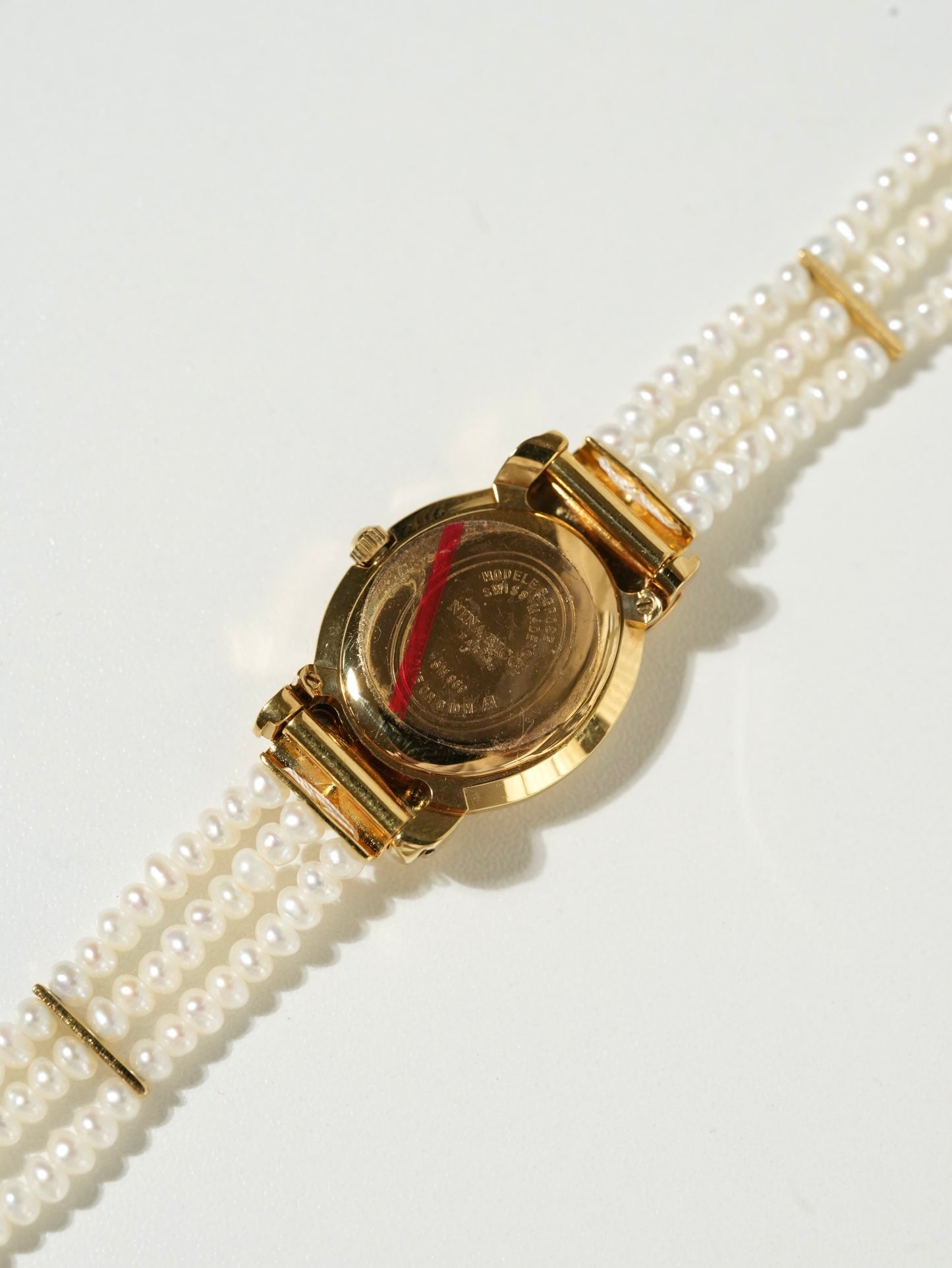Nina Ricci Pearl Bracelet Watch Set – Gold Case, White Dial with Extra Leather Straps